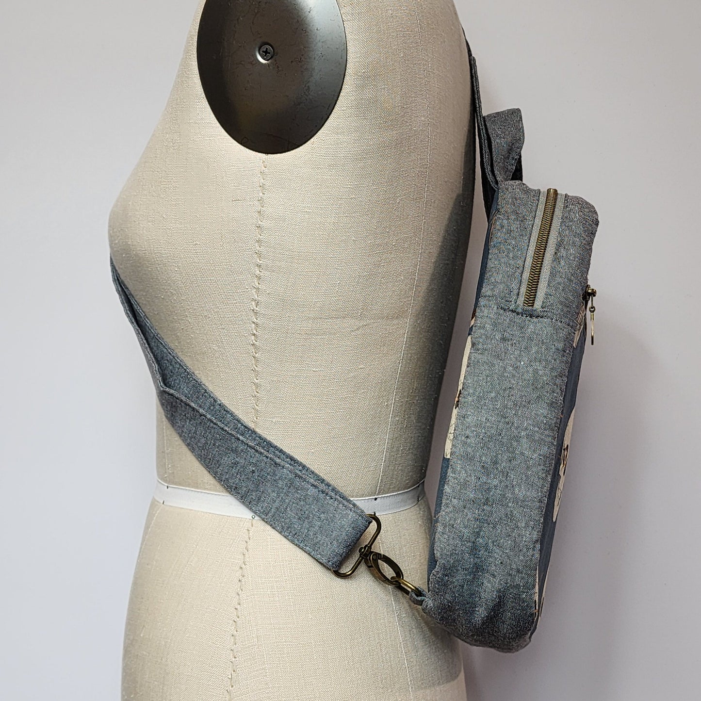 
                  
                    Sling Cross Body Bag in Wrented Skulls
                  
                