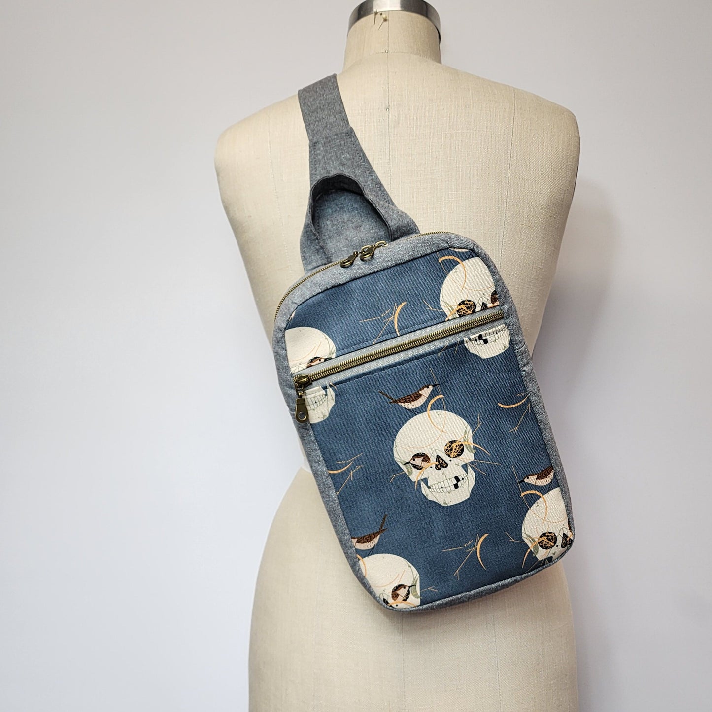 
                  
                    Sling Cross Body Bag in Wrented Skulls
                  
                